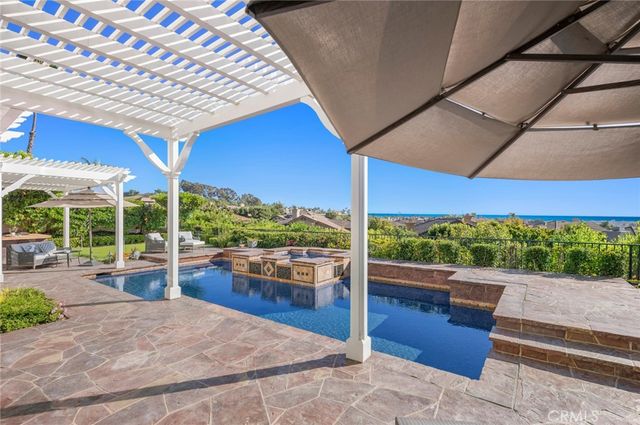 a view of a patio with a table and chairs under an umbrella