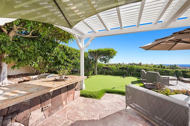 a view of a patio with a table and chairs