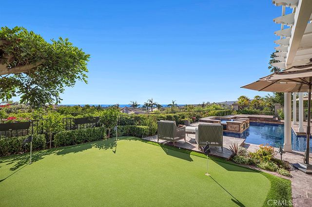 a view of a swimming pool and lounge chairs