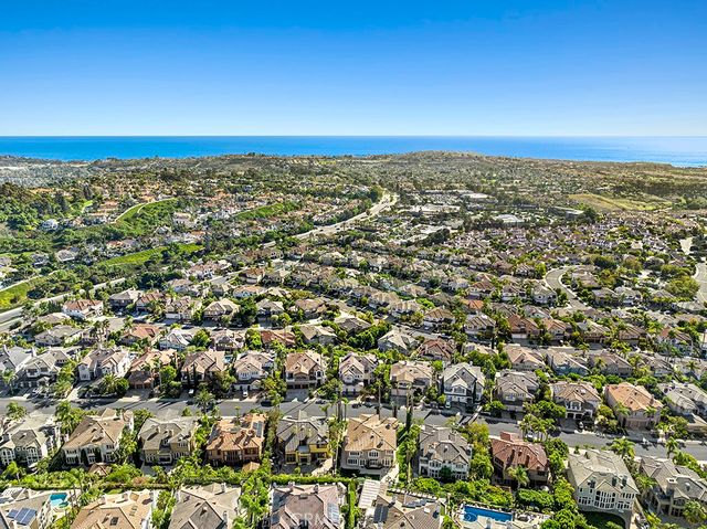 an aerial view of residential houses with city view
