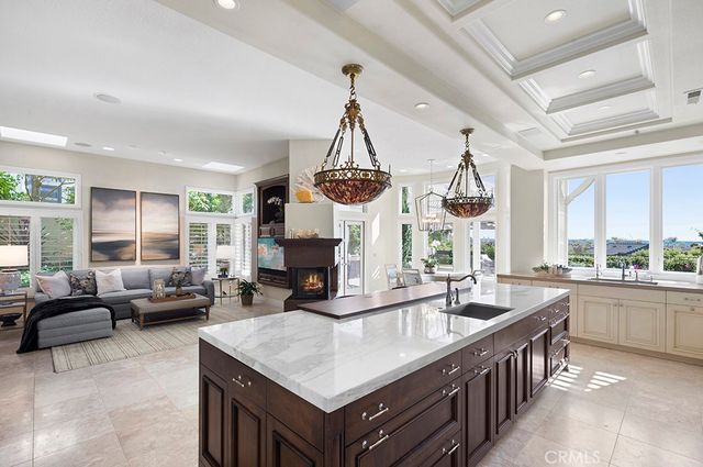 a kitchen with counter top space and windows