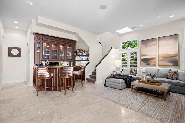 a living room with furniture a flat screen tv and a large window