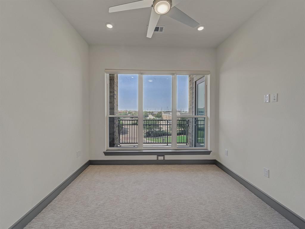 2700 Old Denton Road, Unit 3347 Carrollton, TX 75007 - Photo 12 of 30 an empty room with wooden floor and windows