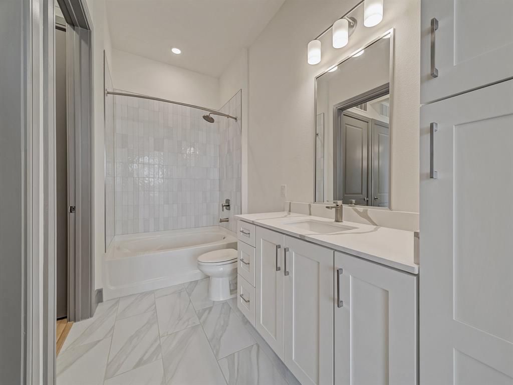 2700 Old Denton Road, Unit 3347 Carrollton, TX 75007 - Photo 13 of 30 a bathroom with a sink a toilet a mirror and shower