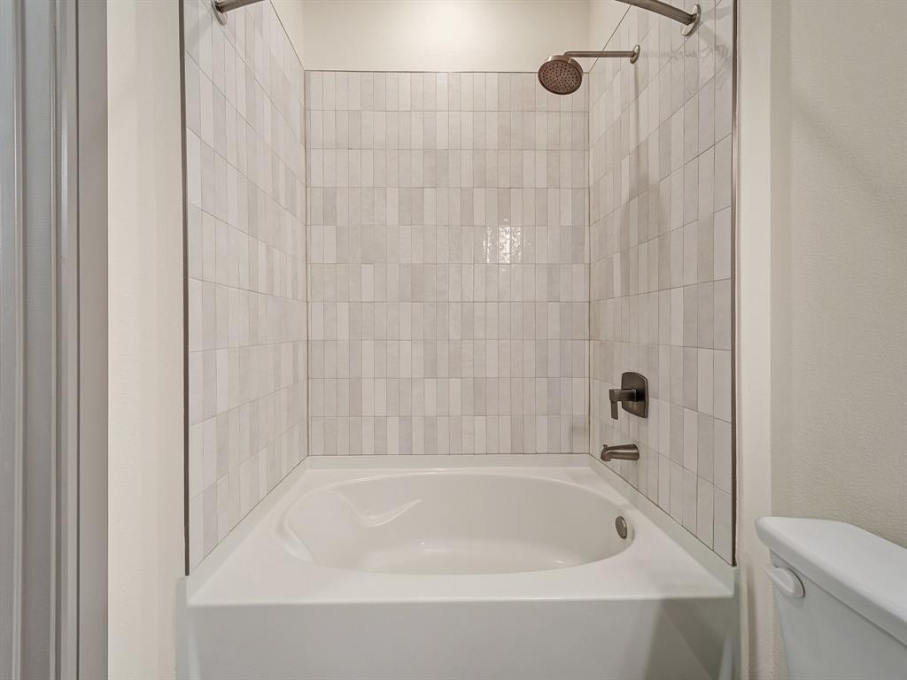 2700 Old Denton Road, Unit 3347 Carrollton, TX 75007 - Photo 14 of 30 a bathroom with a shower and a bath tub