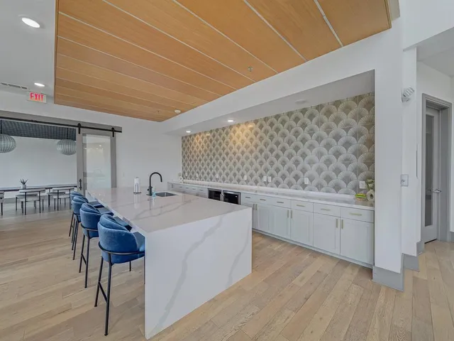 a large white kitchen with sink and white cabinets
