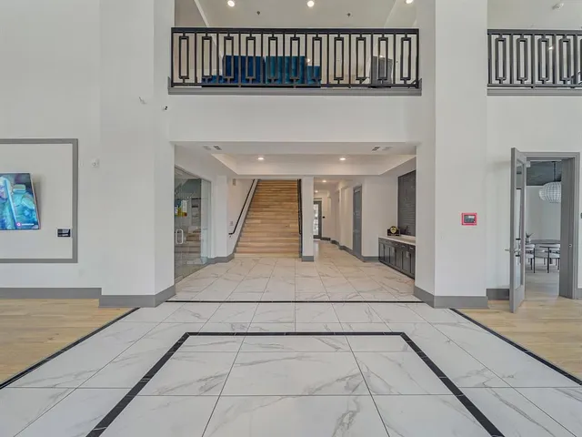 a view of entryway and hall with a bathtub