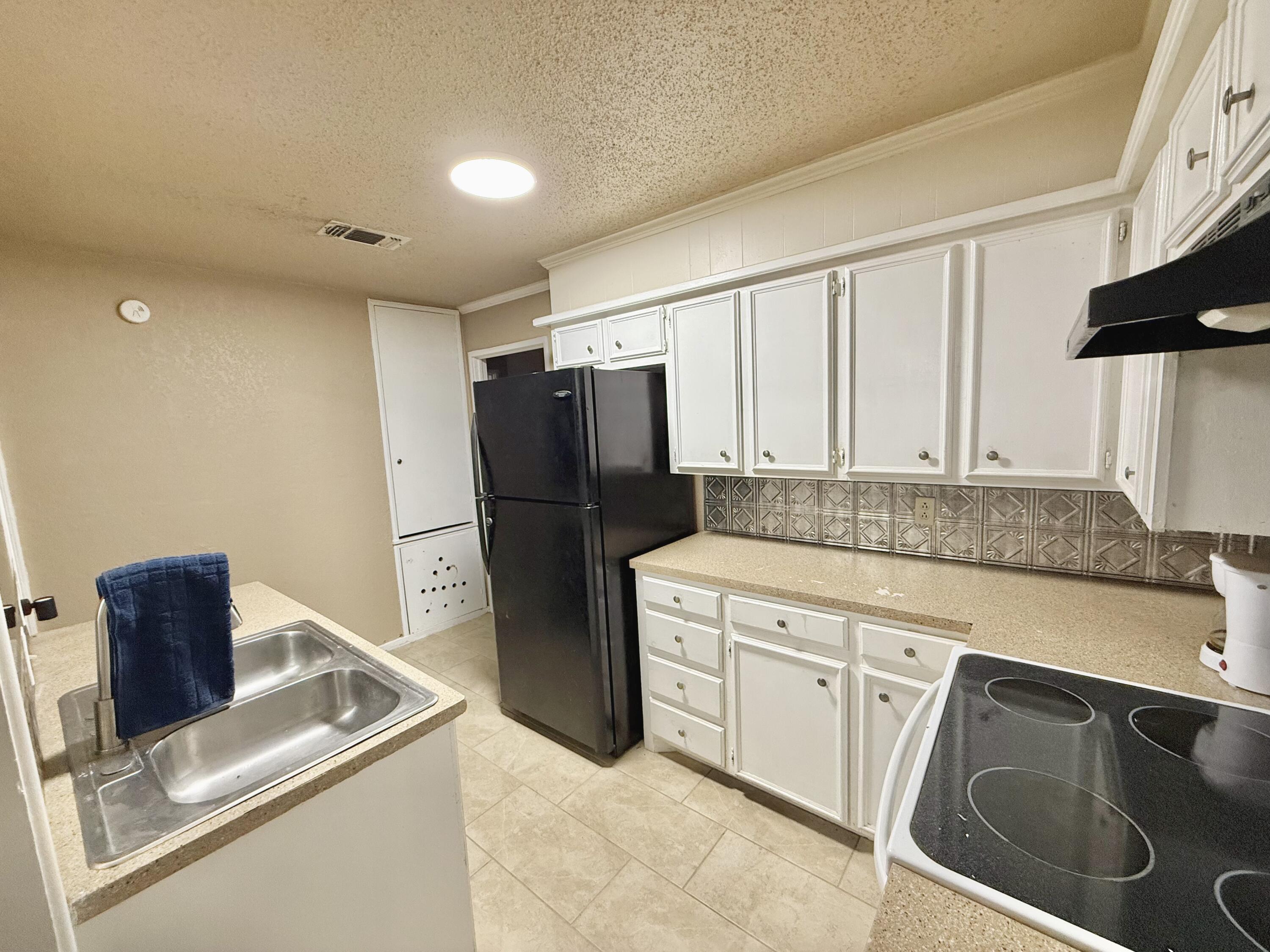 3602 31st Street Lubbock, TX 79410 - Photo 15 of 33 a kitchen with stainless steel appliances granite countertop a refrigerator and a stove top oven