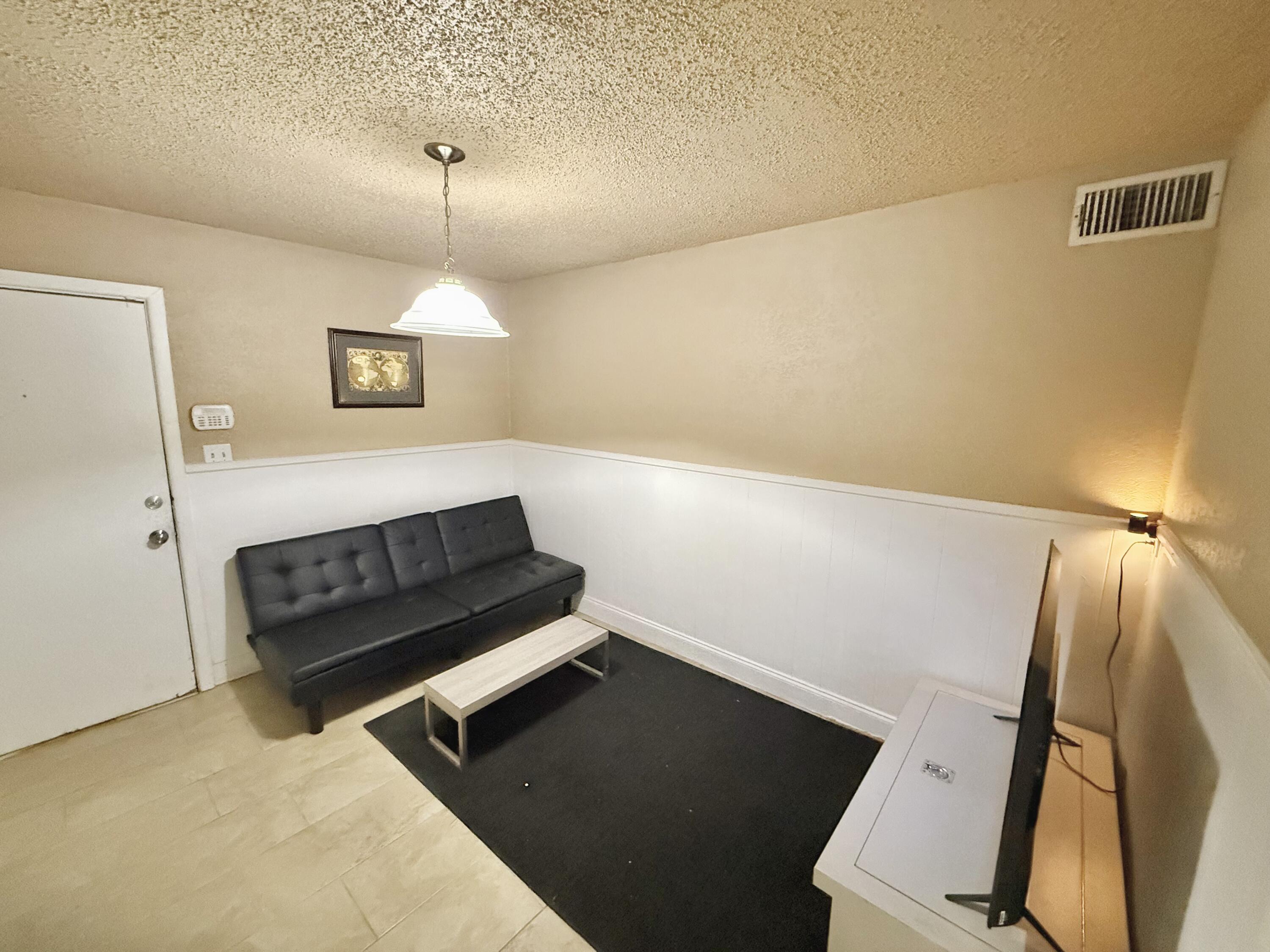 3602 31st Street Lubbock, TX 79410 - Photo 16 of 33 a living room with furniture and a flat screen tv