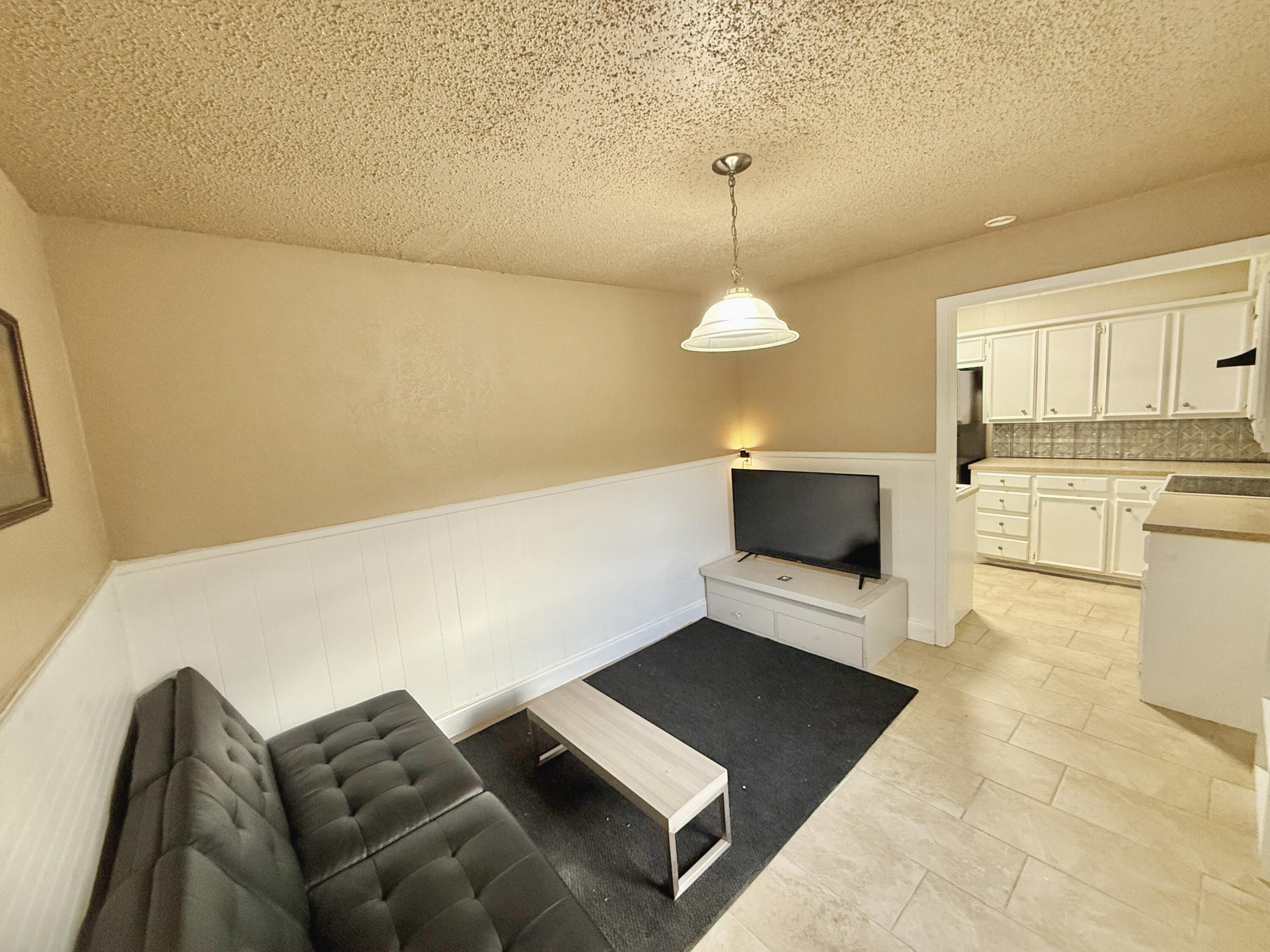 3602 31st Street Lubbock, TX 79410 - Photo 19 of 33 a living room with furniture and a chandelier