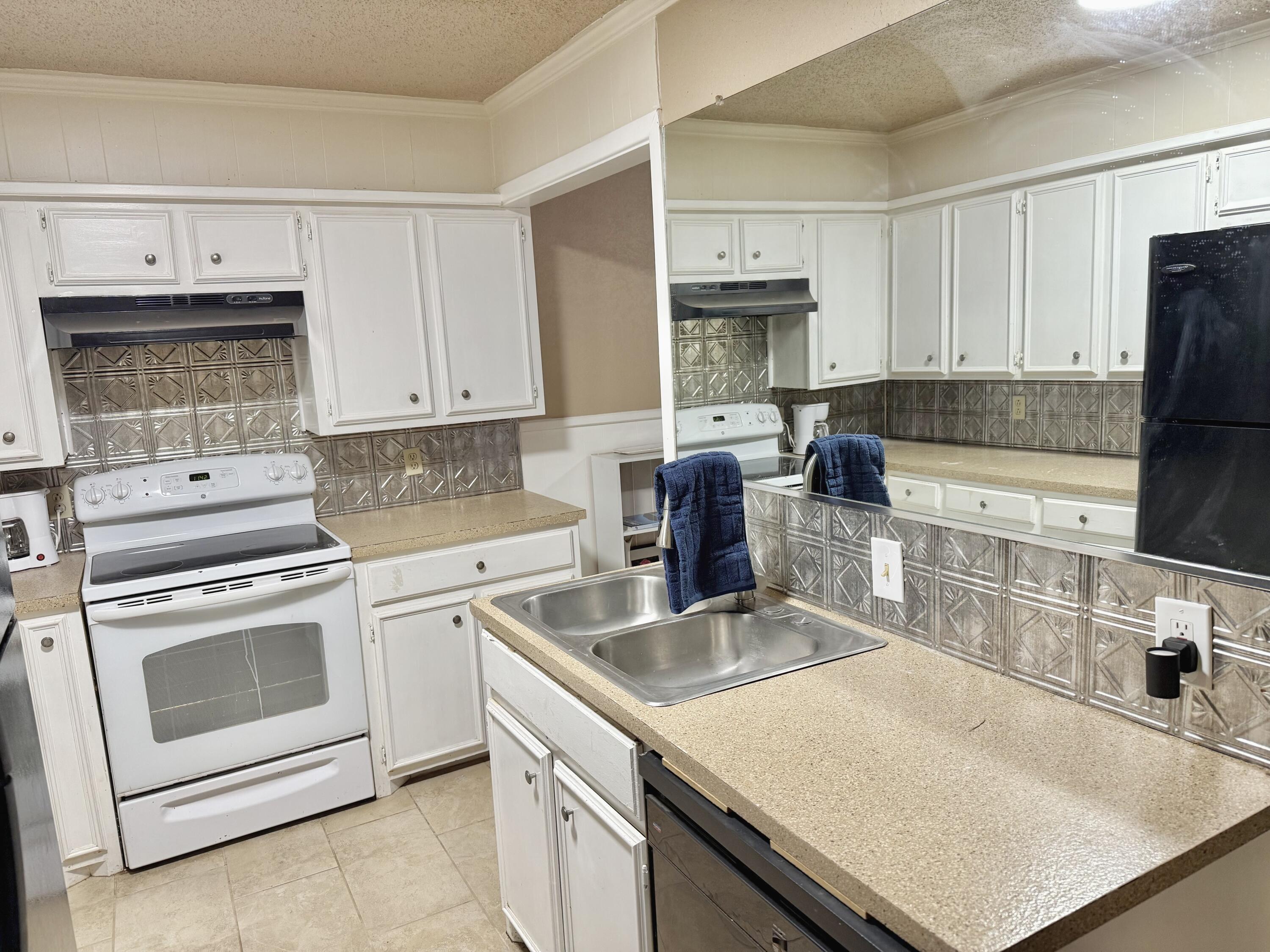 3602 31st Street Lubbock, TX 79410 - Photo 24 of 33 a kitchen with stainless steel appliances granite countertop a sink stove and refrigerator