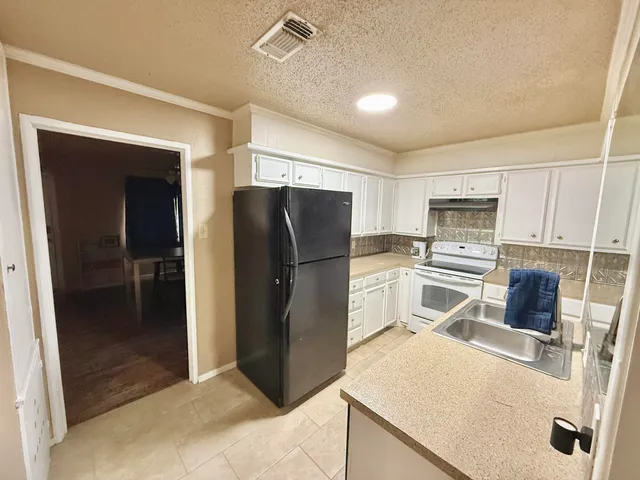 a kitchen with stainless steel appliances a refrigerator and a stove