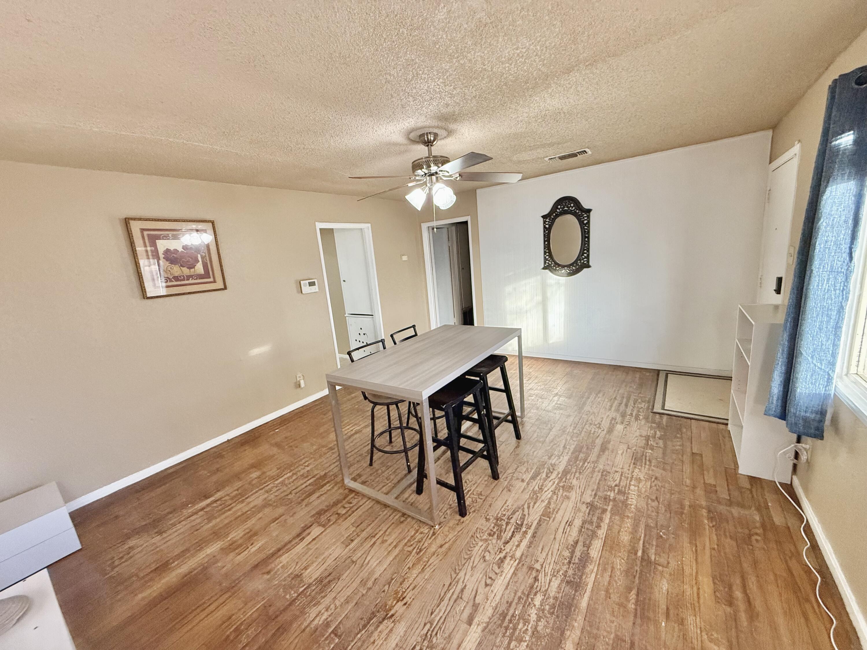 3602 31st Street Lubbock, TX 79410 - Photo 3 of 33 a view of a dining room with furniture and wooden floor