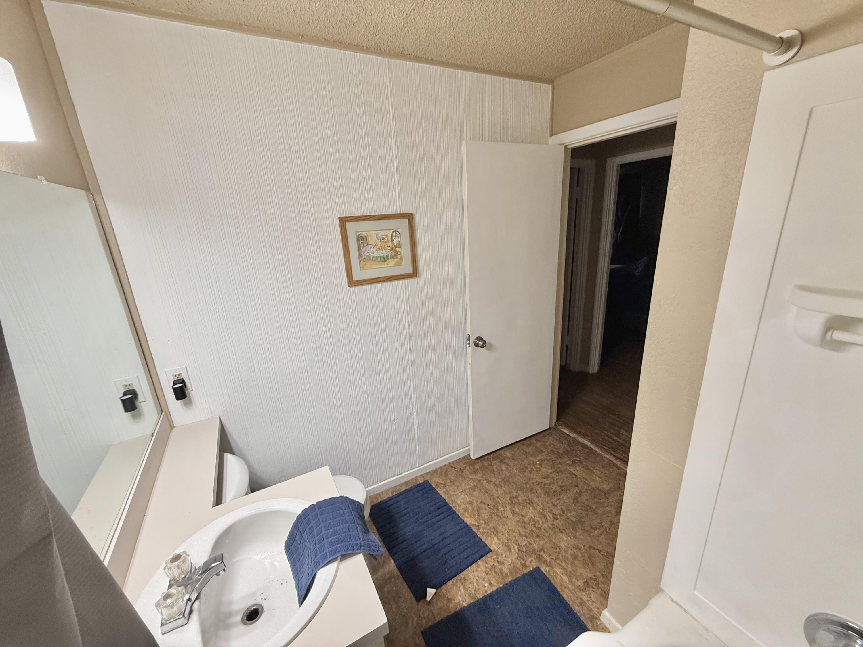 3602 31st Street Lubbock, TX 79410 - Photo 5 of 33 a view of a hallway with wooden floor and furniture