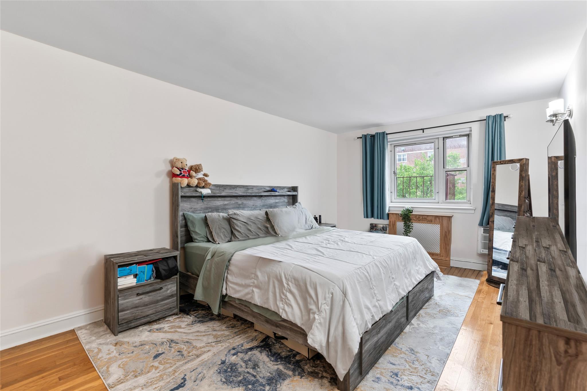 88-12 151st Avenue, Unit 4B Queens, NY 11414 - Photo 11 of 17 a bedroom with a bed and a window