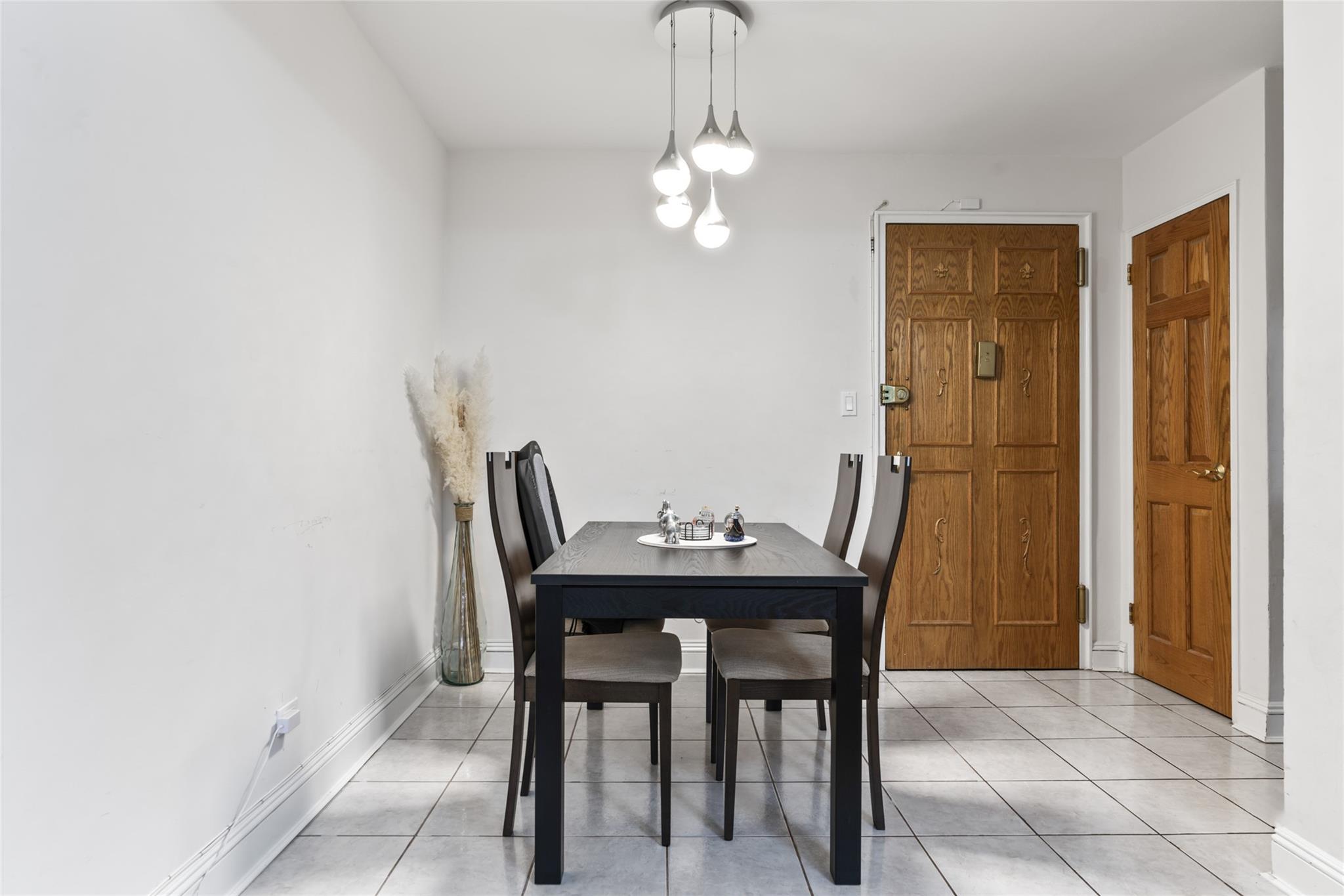 88-12 151st Avenue, Unit 4B Queens, NY 11414 - Photo 5 of 17 a view of a dining room with furniture and wooden floor