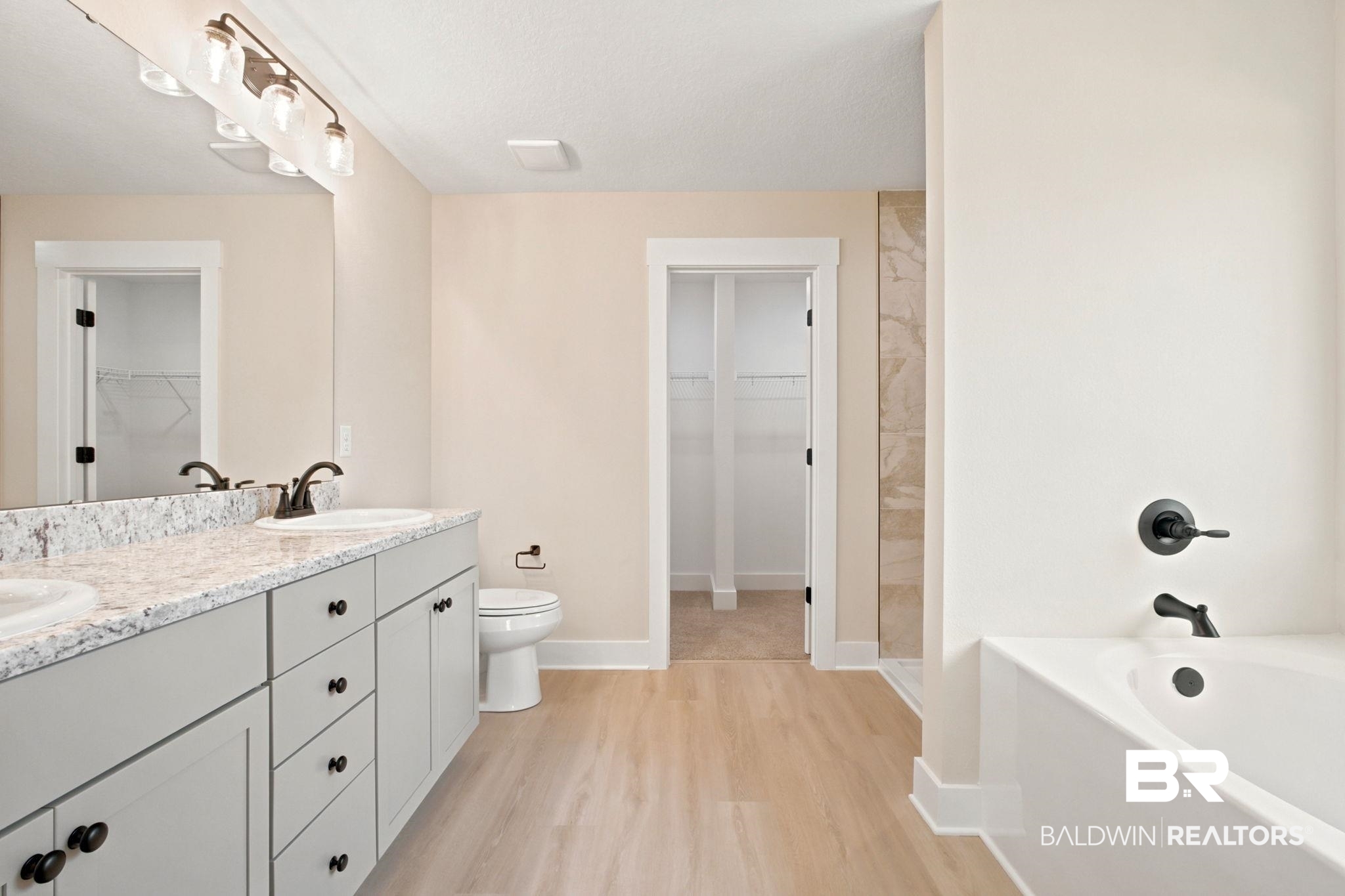32656 Arbor Ridge Circle Lillian, AL 36549 - Photo 17 of 56 Bathroom featuring a double vanity with light gray cabinetry, white countertops, and dual undermount sinks with dark bronze fixtures