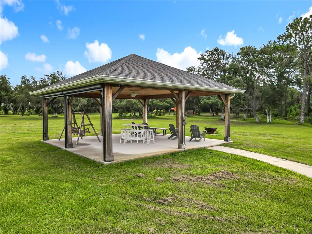10220 Bay Lake Road Groveland, FL 34736 - Photo 61 of 67 a view of a house with backyard and a large tree