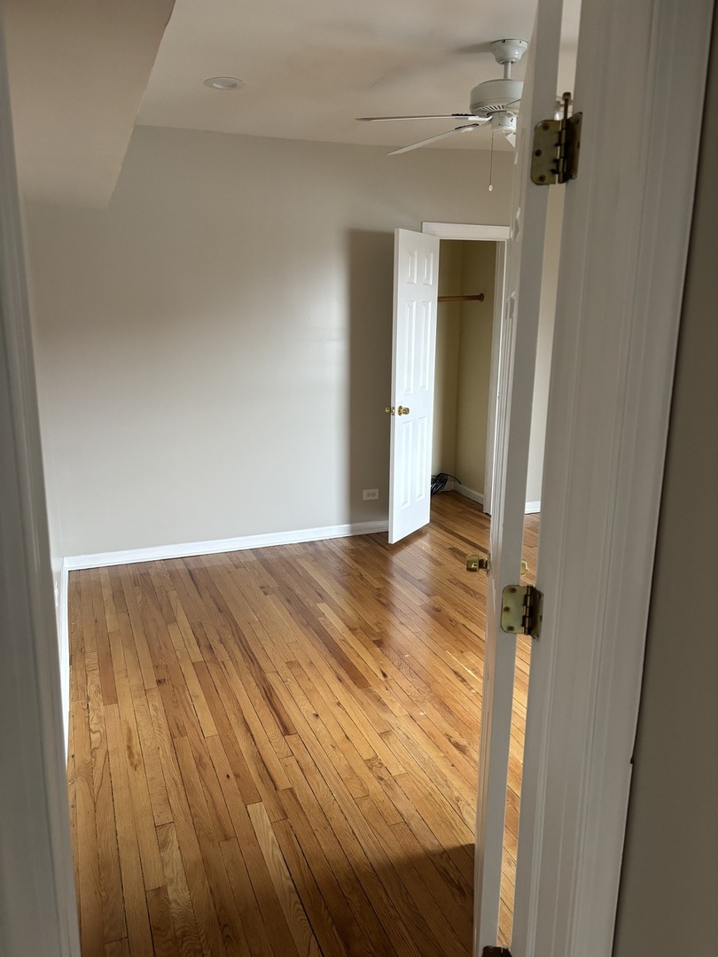 8052 South Aberdeen Street, Unit 3 Chicago, IL 60620 - Photo 3 of 6 wooden floor in an empty room