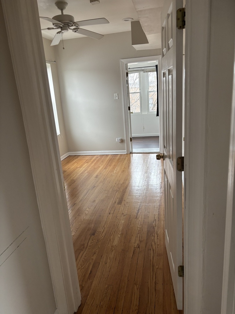 8052 South Aberdeen Street, Unit 3 Chicago, IL 60620 - Photo 5 of 6 wooden floor in an empty room with a window