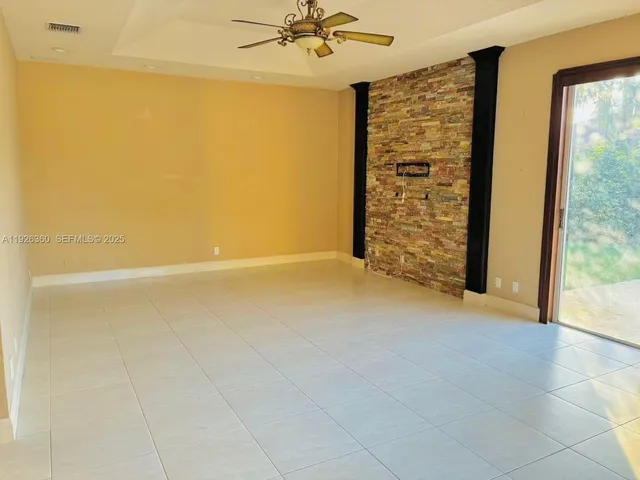 an empty room with windows and cabinet