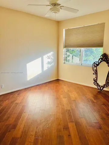 a view of empty room with floor to ceiling window