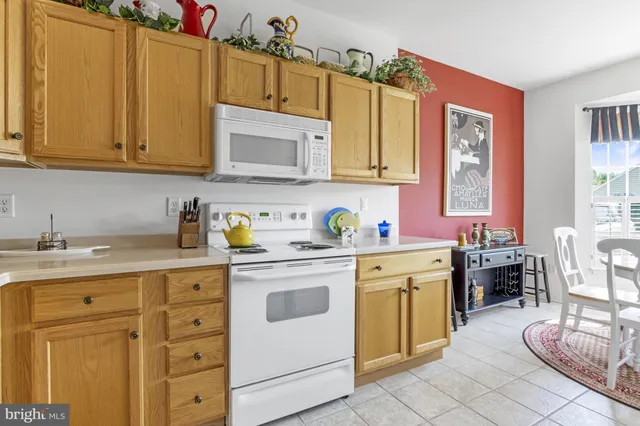 a view of a dining room with furniture and a chandelier