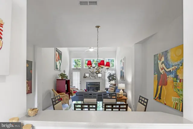 a living room with furniture a fireplace and a large window