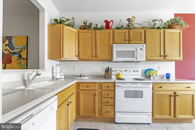 a living room with furniture and a baby crib