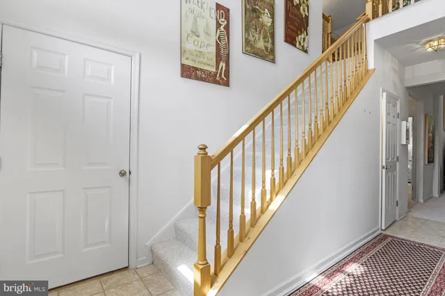 a living room with furniture a rug and a wall painting