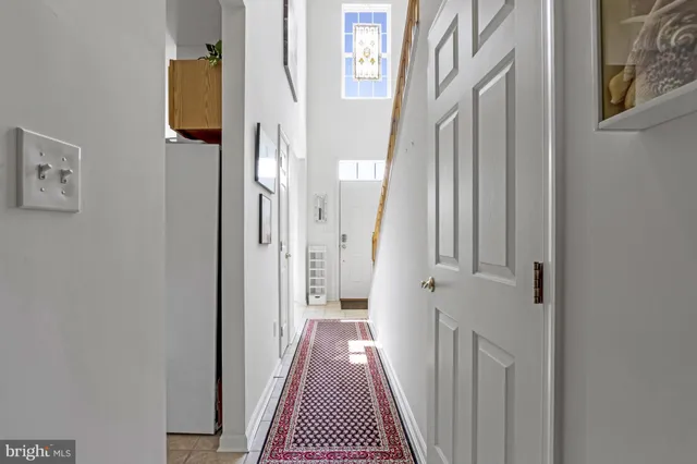 a bedroom with a bed and a mirror on the dresser