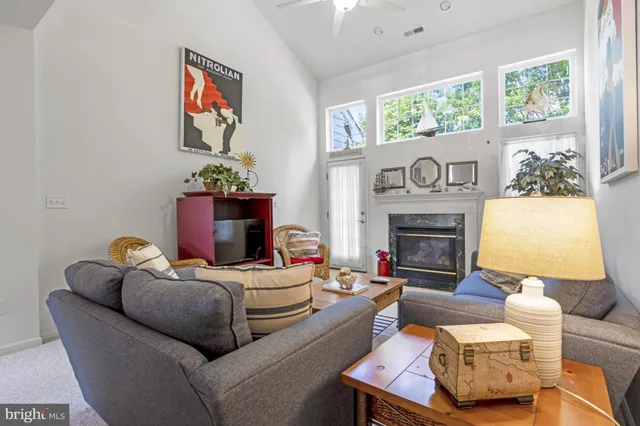 a living room with furniture and a book shelf