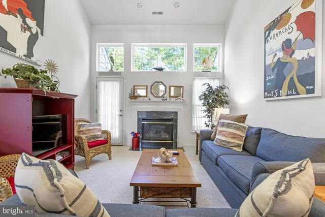 a living room with furniture a fireplace and a window