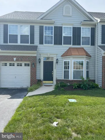 a front view of a house with a garden and yard