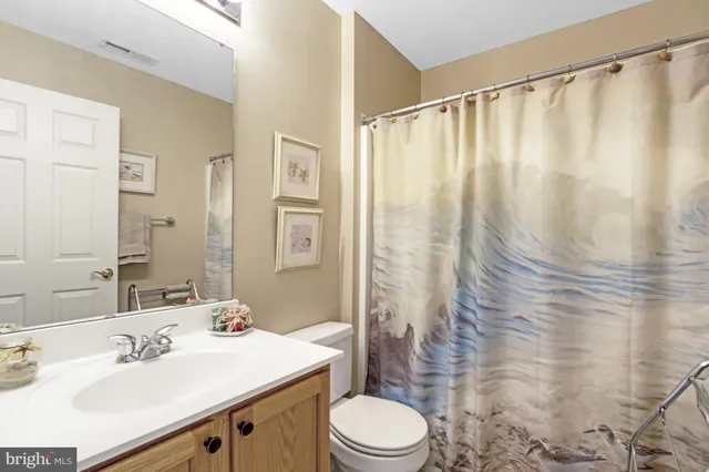 an aerial view of a city with lots of residential buildings ocean and mountain view in back