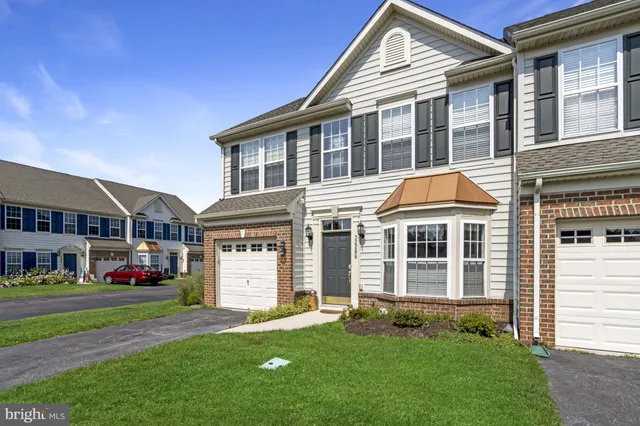 a dining room with a table chairs and a chandelier