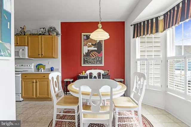a view of staircase with lots of frames on wall and a window