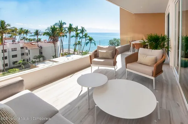 a balcony with furniture and a potted plant