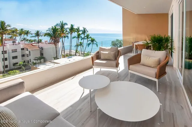 a balcony with furniture and a potted plant