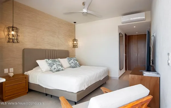 a bedroom with a bed and a television