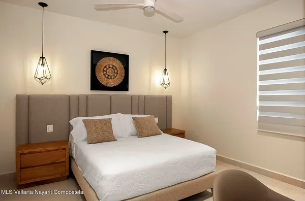 a bedroom with a bed and a window