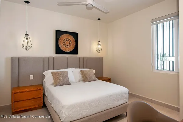 a bedroom with a bed and chandelier