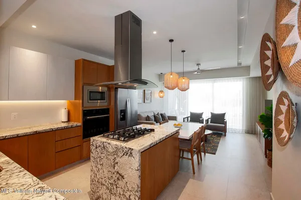 a kitchen with a refrigerator a stove and a sink