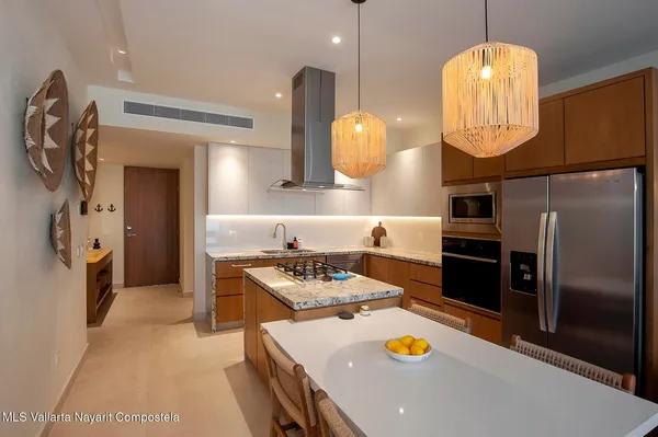 a dining room with wooden floor a table and chairs