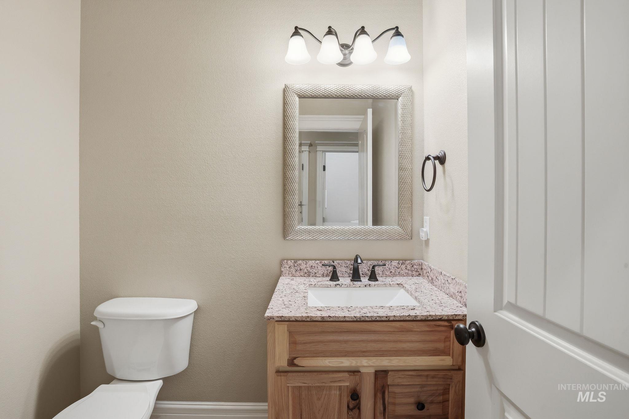 3969 North Hollymount Way Meridian, ID 83646 - Photo 36 of 47 Bathroom vanity featuring a light-toned granite countertop, undermount sink, and dark bronze faucet