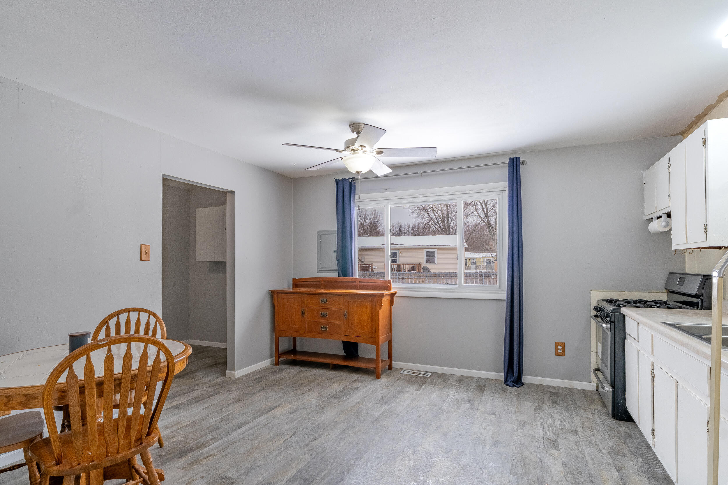 419 Portland Road Valparaiso, IN 46385 - Photo 7 of 21 a living room with furniture and a dining table with wooden floor