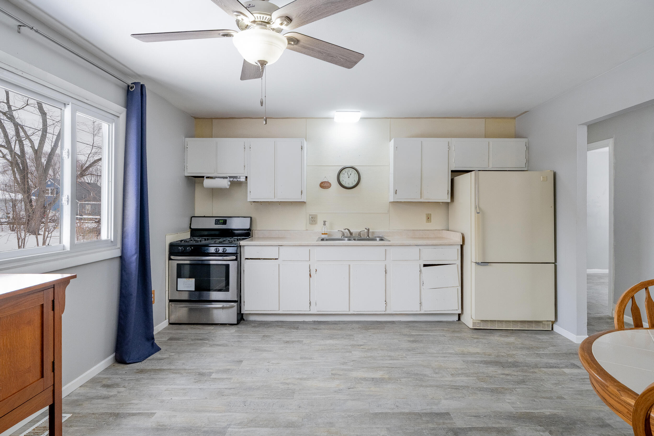 419 Portland Road Valparaiso, IN 46385 - Photo 9 of 21 a kitchen with a refrigerator stove and white cabinets