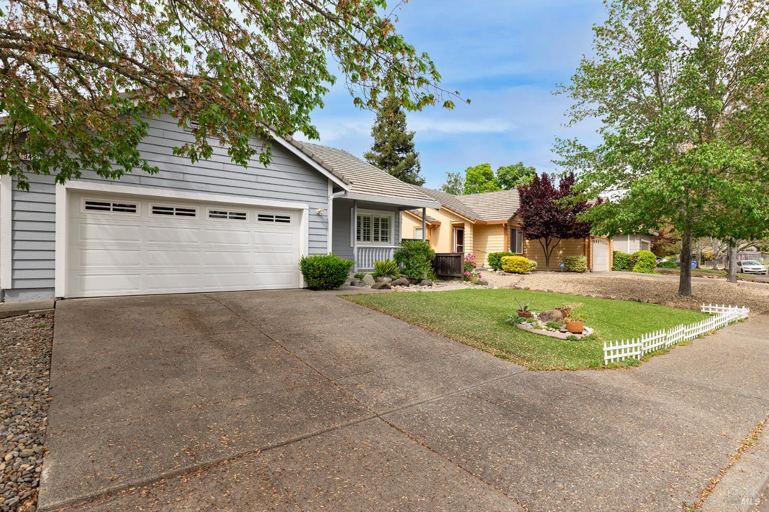 349 Sugar Maple Lane Windsor, CA 95492 - Photo 1 of 47 a front view of a house with a garden and trees