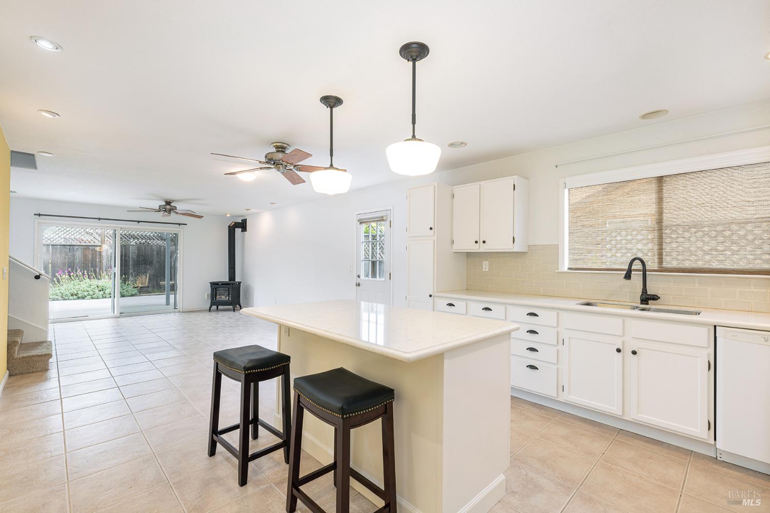 349 Sugar Maple Lane Windsor, CA 95492 - Photo 14 of 47 a large kitchen with kitchen island a sink stainless steel appliances and cabinets