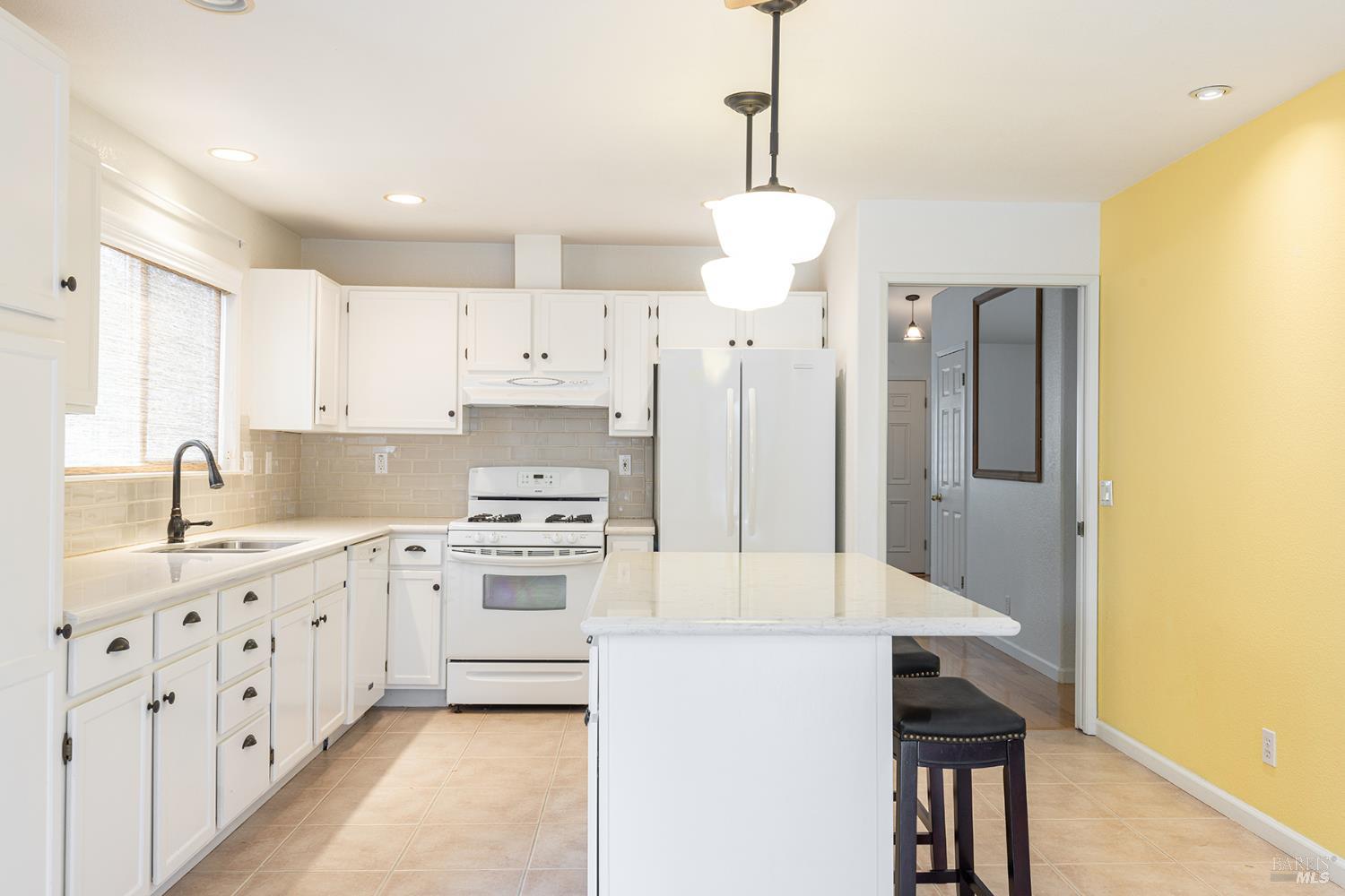 349 Sugar Maple Lane Windsor, CA 95492 - Photo 16 of 47 a kitchen with stainless steel appliances a stove a sink and a refrigerator